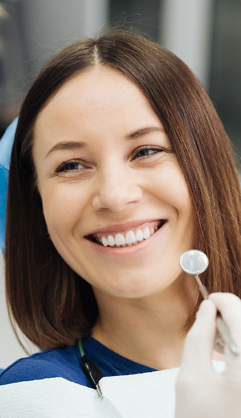 The image shows a modern dental or medical office interior with a dental chair, equipment, and a clean, professional environment.